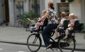 mother and her three children having a ride through a city iin the Netherrlands